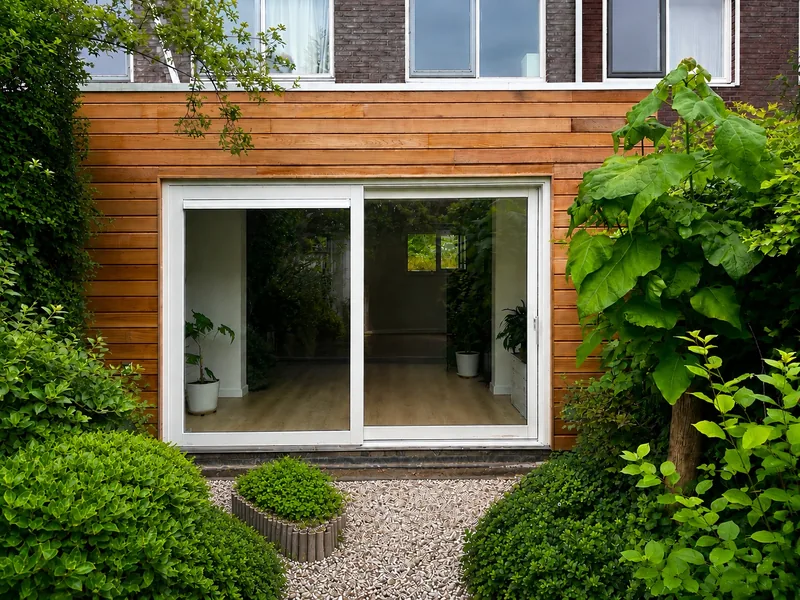 After: From the garden: glass conservatory to extension