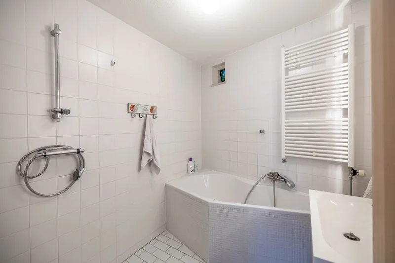 Before: Bathroom: tub to spacious walk-in shower