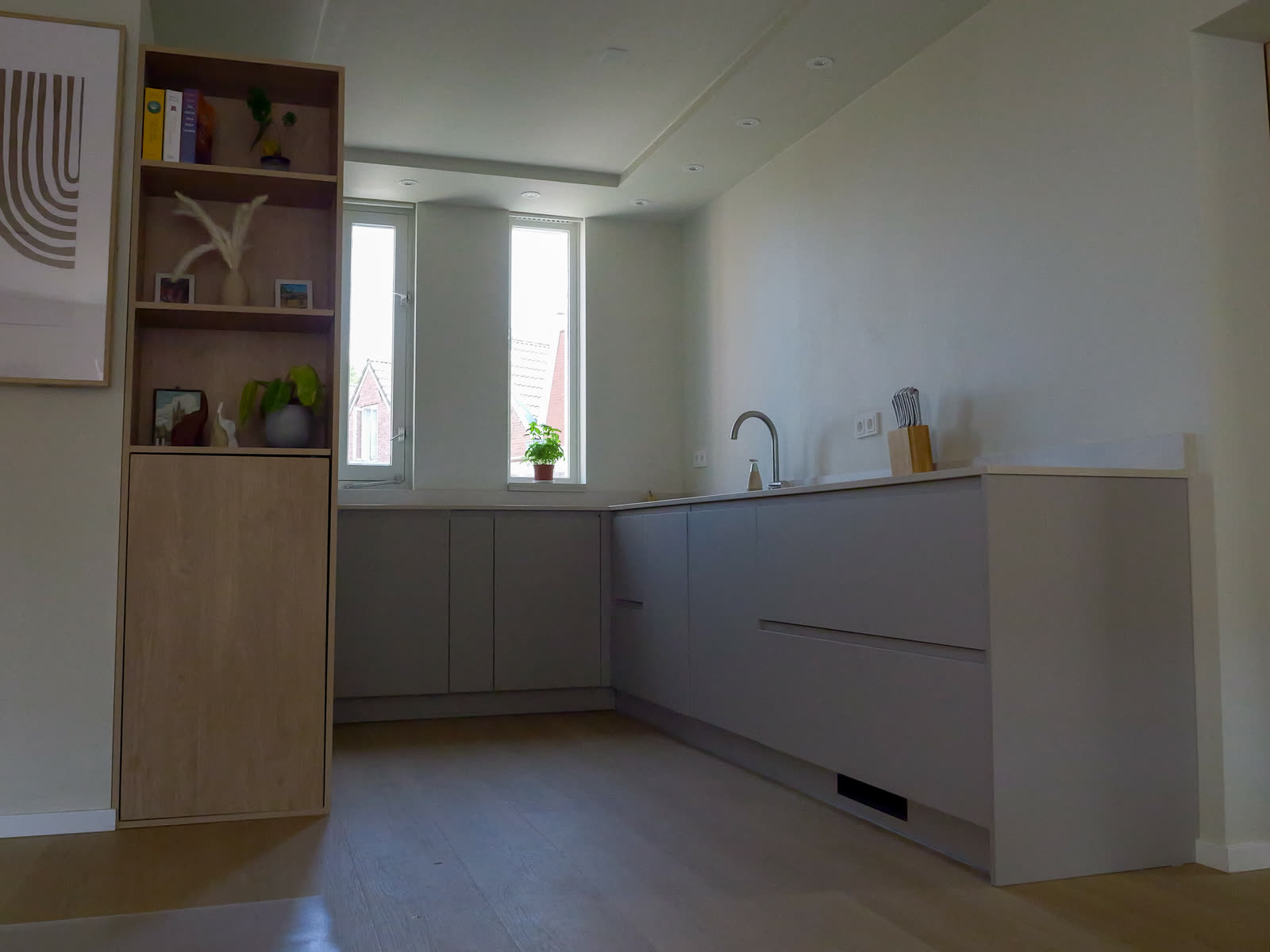 Nieuwe greeploze keuken Allermanstraat Groningen met composiet werkblad en eiken kastenwand