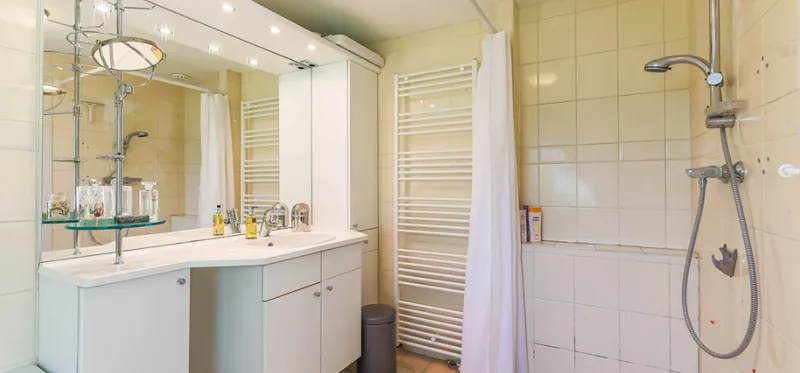 Before: Curtained shower corner to a spacious walk-in shower